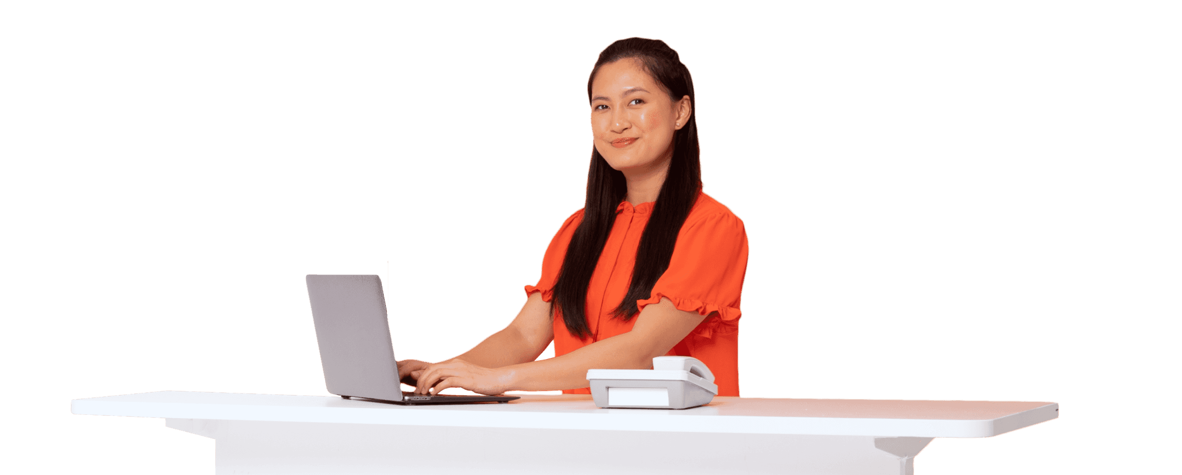 A woman typing on her laptop while smiling